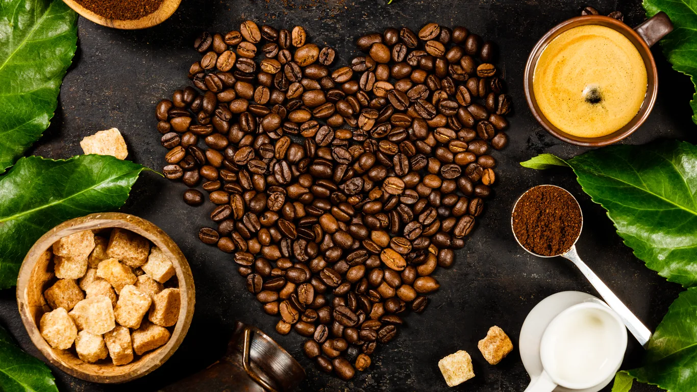 Panama specialty coffee - Coffee Beans And Green Leaves On Dark Surface