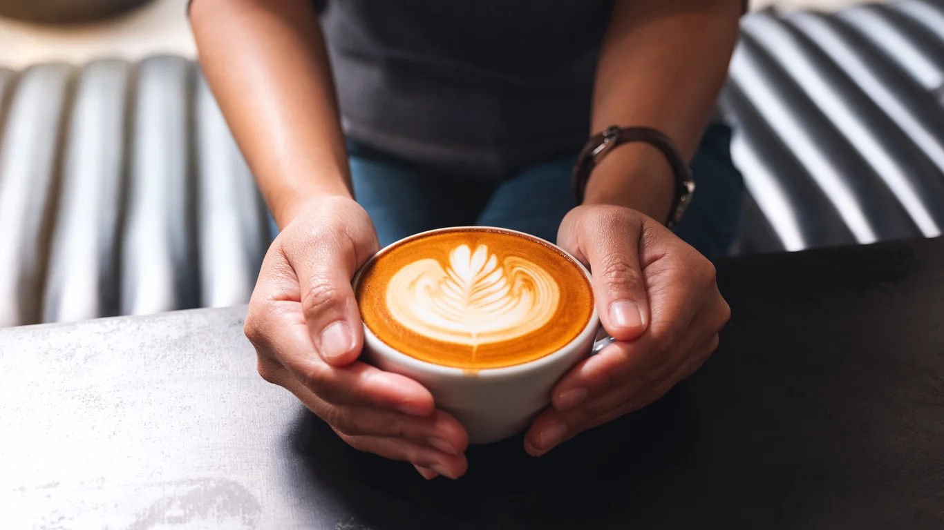Panama specialty coffee - Hands Holding Cup Of Latte Coffee Art