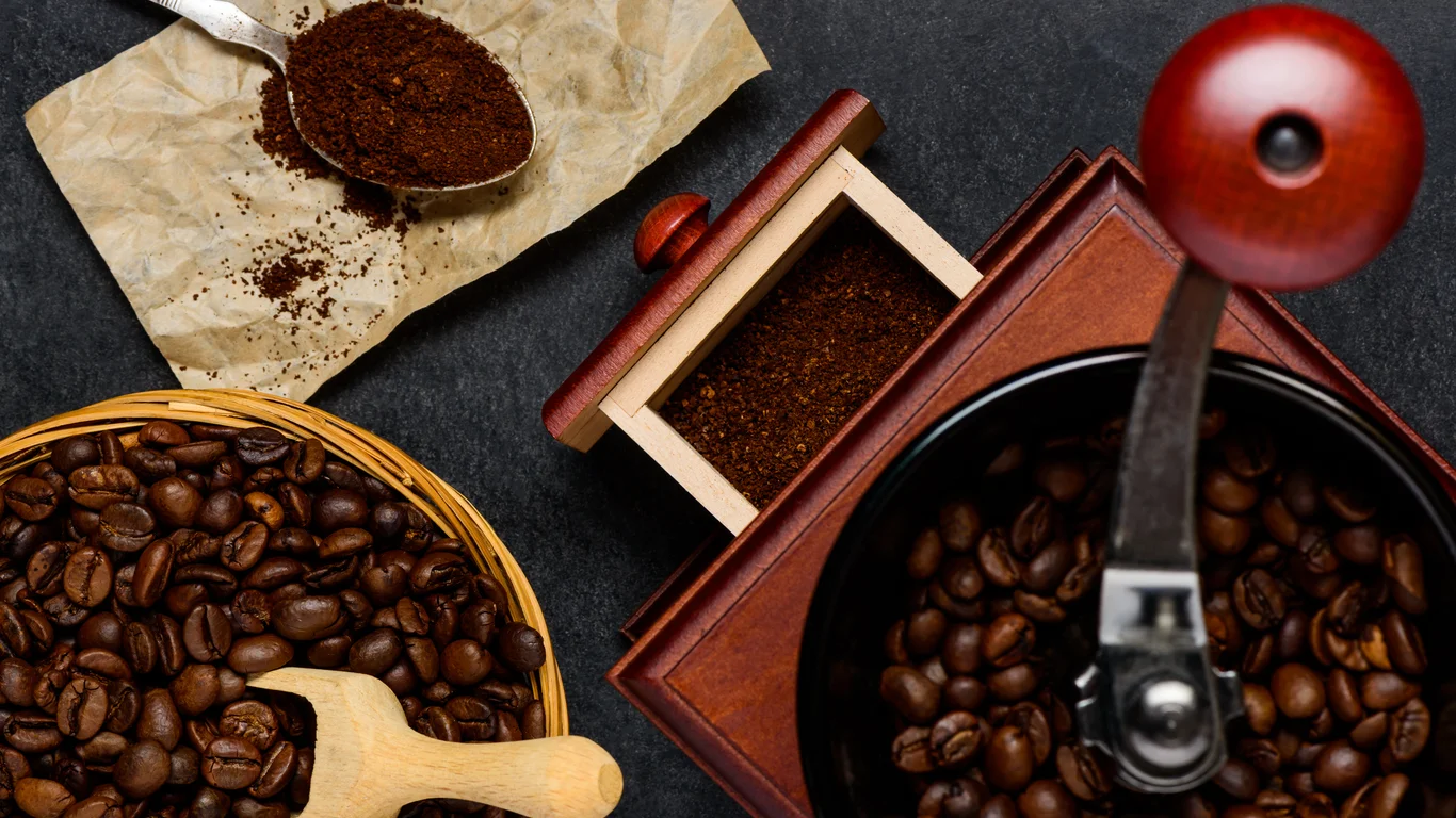 Panama specialty coffee - Roasted Coffee Beans And Grinder On Dark Surface